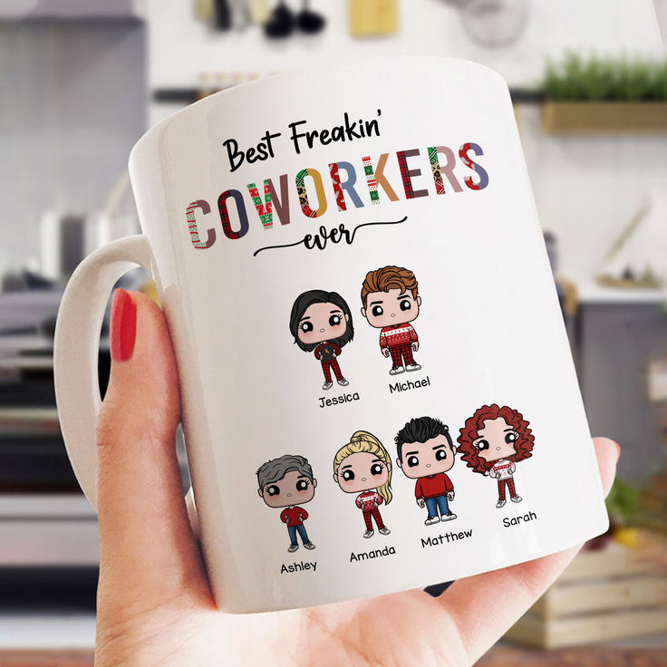 a person holding a coffee mug with the words best freakin'coworkers on it