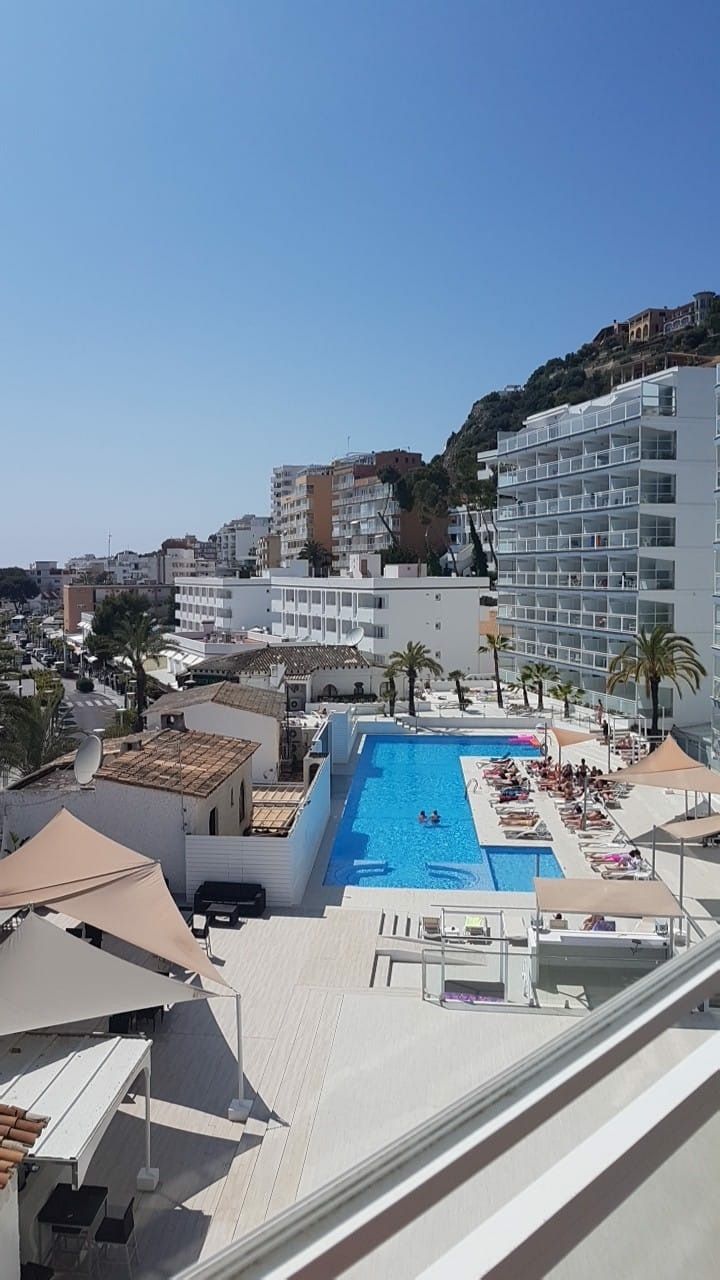 an aerial view of the pool and surrounding buildings