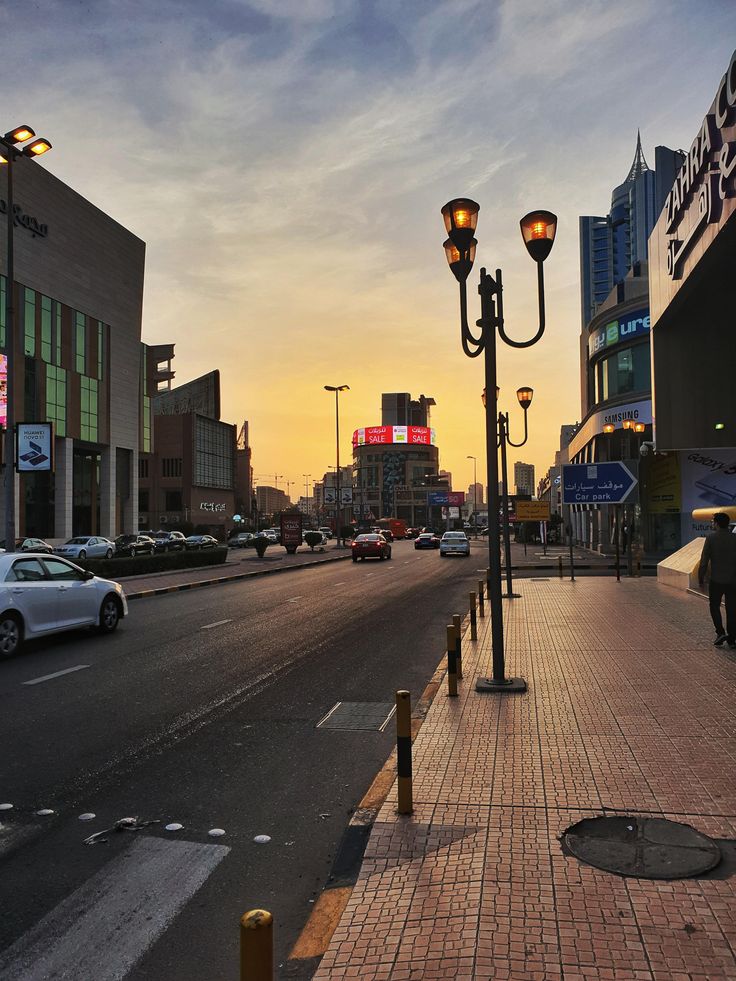 a city street with cars parked on the side of it