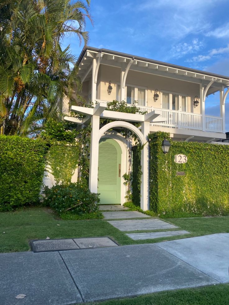 a white house with a green door in front of it