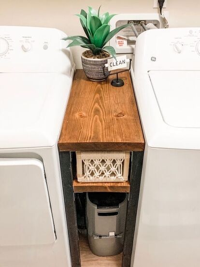 a washer and dryer sitting next to each other in a room with wood flooring