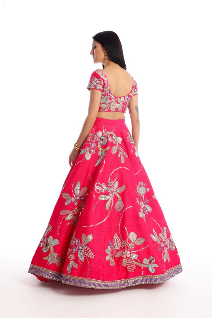 Kinfolk Carmine pink applique embellished raw silk lehenga, blouse & tulle dupatta. From Aisha Rao's Kinfolk collection. DELIVERY TIMEPlease allow 6-8 weeks for your outfit to arrive. FABRIC DETAILSRaw Silk Professional cleaning only.