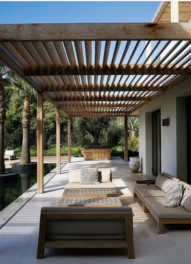 an outdoor covered patio with couches and tables