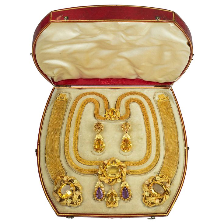 A fine Georgian citrine and gold parure, consisting of a necklace, a pair of earrings and a pair of bracelets, the necklace consisting of an oval-cut faceted citrine surrounded by a gold frame of foliate design, suspending three detachable drop-like pendants, each centrally-set with a pear-shaped citrine, all suspended by a double strand of tubular mesh chain with box clasp of similar design, set with an oval faceted citrine, each bracelet with a clasp of similar design, each centrally set with Pear Shaped Face, Victorian Pendant Necklace, Georgian Jewelry, Victorian Pendants, Display Jewelry, Citrine Jewelry, Vintage Fine Jewelry, Coral And Gold, Box Clasp