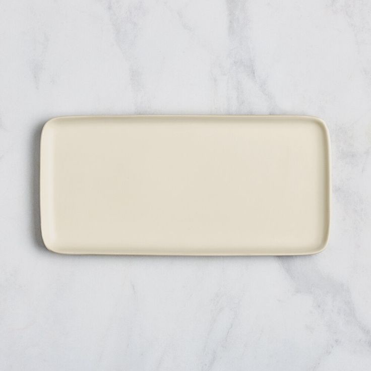 a white rectangular plate sitting on top of a marble counter