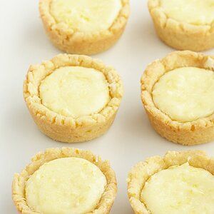 several small pies sitting on top of a white table