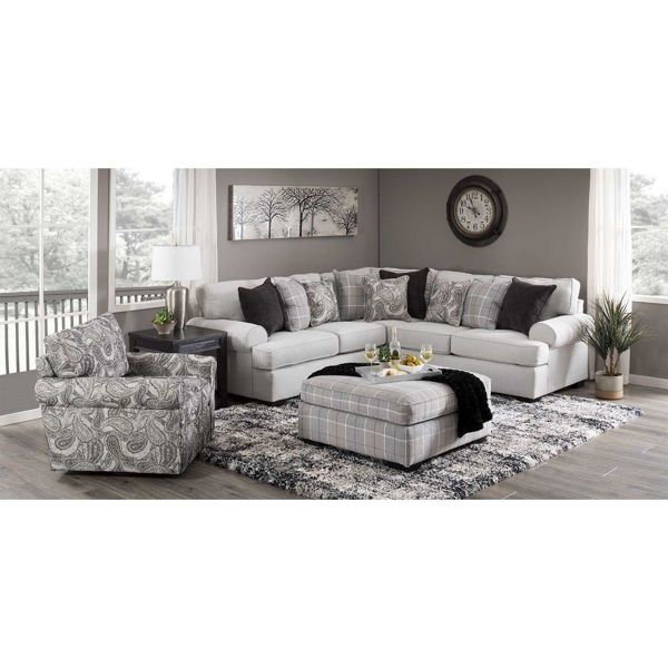 a living room filled with furniture and a large clock on the wall above the couch