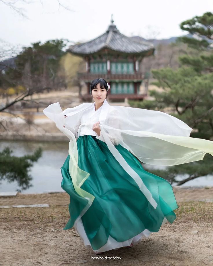 a woman in a long green and white dress