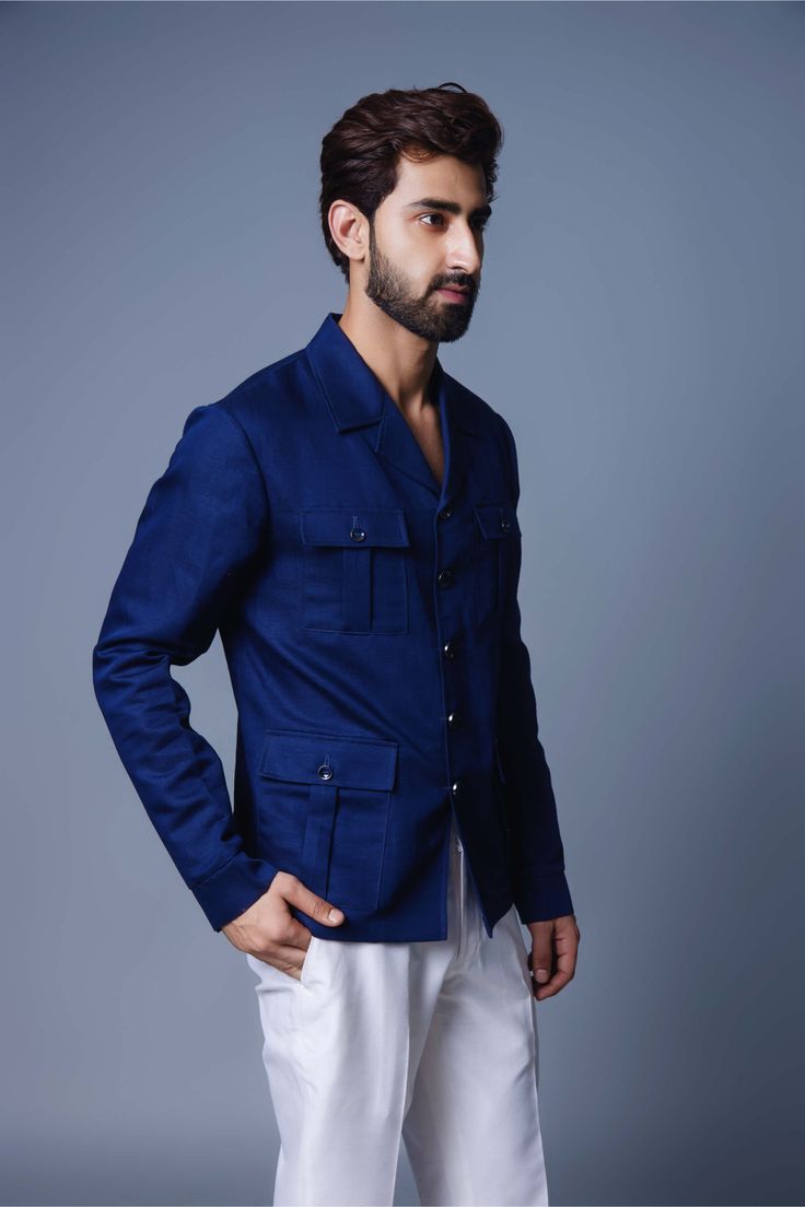 Editor's Note Introducing a navy blue solid shacket, a versatile and timeless wardrobe staple. This shacket combines the structure of a shirt with the functionality of a jacket, making it perfect for layering or wearing on its own. The deep navy blue color adds a touch of sophistication and versatility, allowing for easy coordination with a variety of outfits. Crafted from high-quality materials, this navy blue solid shacket offers both comfort and style, making it a must-have piece for any fash Navy Button-up Outerwear With Patch Pockets, Navy Cotton Outerwear With Buttoned Pockets, Indigo Shirt With Pockets For Fall, Navy Single-breasted Button-up Blazer, Navy Collared Outerwear With Buttoned Pockets, Cotton Blazer With Flap Pockets And Long Sleeves, Blue Denim Jacket With Notch Lapel And Pockets, Blue Long Sleeve Outerwear With Buttoned Pockets, Indigo Cotton Outerwear With Buttoned Pockets