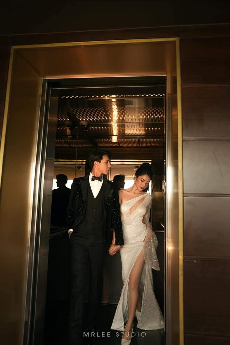 a man and woman standing in an elevator