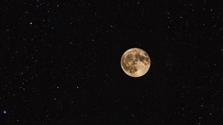 the full moon is shining brightly in the dark night sky with stars all around it