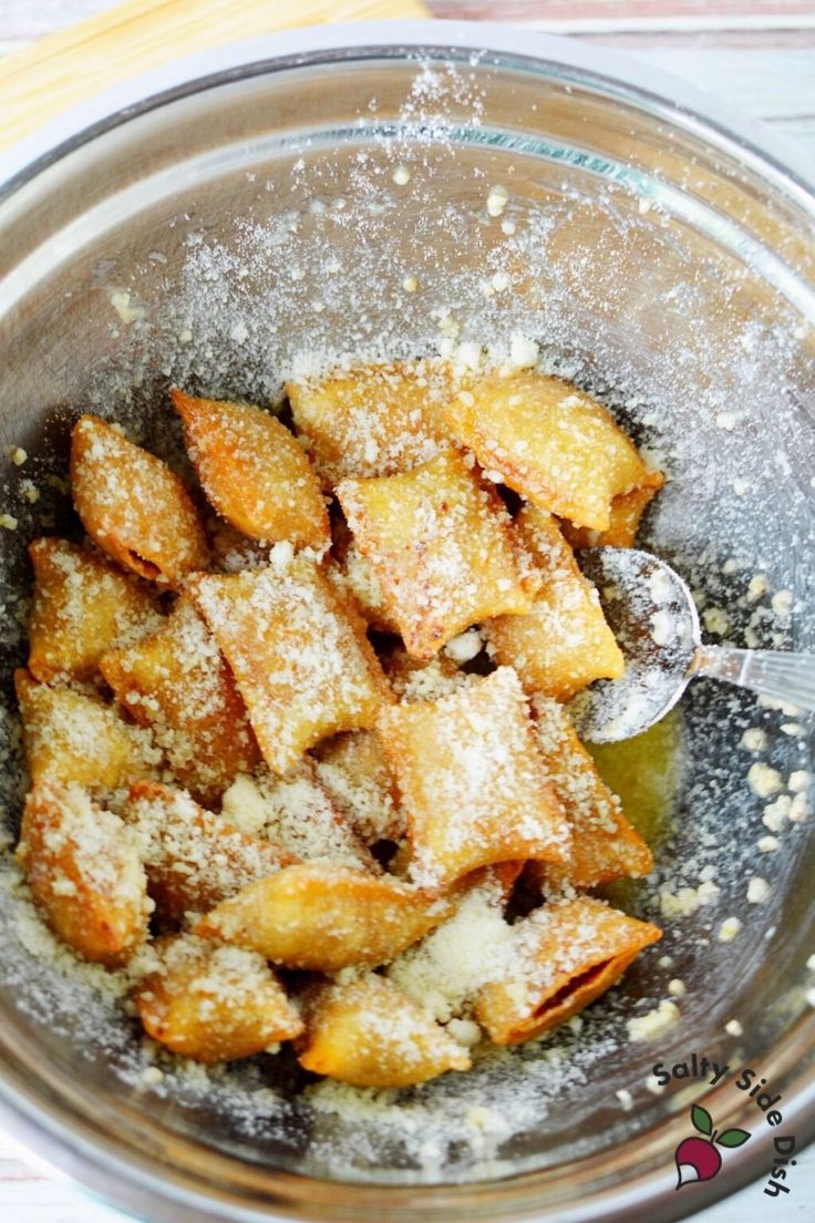 a bowl filled with powdered sugar on top of a table