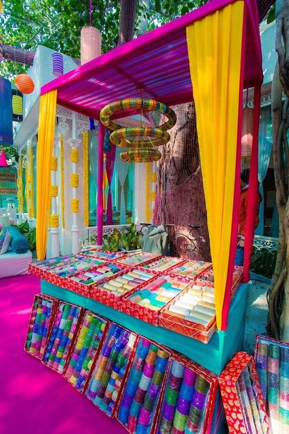 an outdoor area with colorful fabrics and decorations