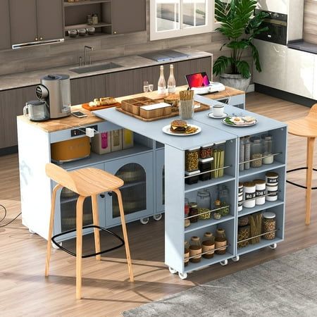 a kitchen island with two stools in front of it and shelves on the other side