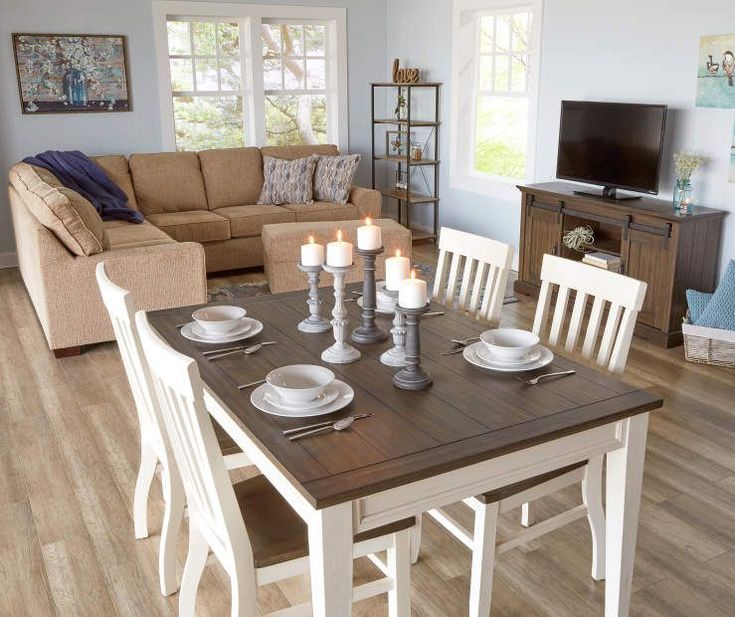 a living room and dining area with couches, chairs, table and television in it