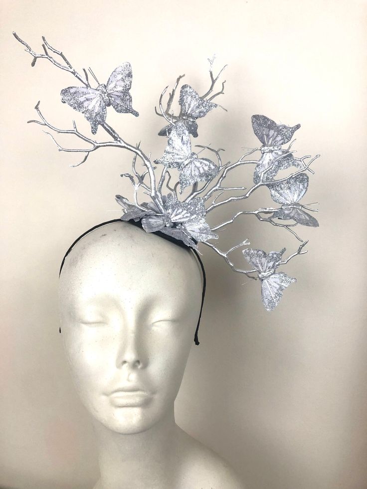 "Derby- Ladies lunch- Easter bonnet- silver headpiece  Hello,           All silver headband with silver branches and silver glitter butterflies. This fascinator is made with butterflies that are 3\" wide. They are perched on branches that are plastic that are painted and will not break as natural ones would. It is attached to a satin covered skinny headband and is adjustable. It's very comfortable and will fit any size head. -------------------------------- I've been making hair pieces over 20 y Silver Headband For Evening, Silver Adjustable Evening Headpieces, Adjustable Silver Headpiece For Carnival, Silver Adjustable Headpieces For Carnival, Adjustable Silver Headband For Evening, Silver Evening Headband, Adjustable Silver Headband Fascinator, Silver Evening Fascinator For Kentucky Derby, Silver Fascinator For Evening At Kentucky Derby