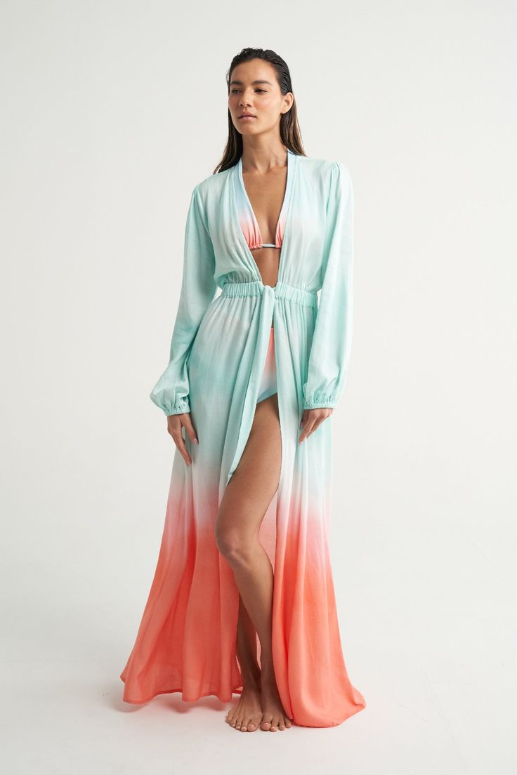 The SIGAL long sleeve cover up is a feminine, yet ultra comfortable piece of resort wear. With flirty puff long sleeves, it can be worn completely open over your swimsuit or tied at the waist. It is the perfect piece to take you from beach to bar. Handcrafted in luxurious fabric, with a soft linen weave and effortless viscose drape, it features hand painted prints by SIGAL herself. Relaxed Fit. Long printed fabric ties sewn to the center front. Encased elastic all around the waist for extra comf Chic Long Sleeve Poolside Cover-up, Chic Long Sleeve Loungewear Cover-up, Chic Long Sleeve Cover-up For Beach Party, Chic Long Sleeve Beach Cover-up, Chic Long Sleeve Swimwear For Beach Party, Long Sleeve Swimwear For Beach Season Vacation, Long Sleeve Swimwear For Vacation During Beach Season, Long Sleeve Beachwear Cover-up For Brunch, Long Sleeve Summer Poolside Cover-up