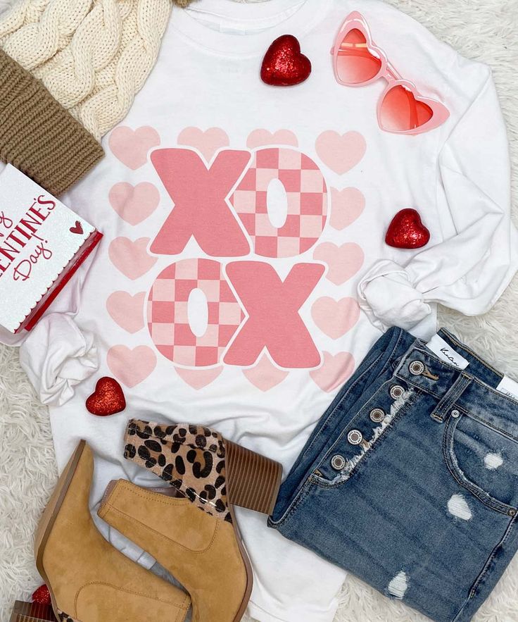 Introducing our "XOXO Valentine Graphic Tee," a delightful and expressive addition to your wardrobe, perfect for celebrating the season of love. Available in short sleeve, long sleeve, and sweatshirt variations, this tee lets you choose the style that suits your comfort and the weather.
The design features the classic XOXO symbol, representing hugs and kisses, with a playful and charming twist for Valentine's Day. The letters are creatively arranged, creating a visually appealing and romantic graphic that captures the spirit of the occasion.
Crafted from high-quality and comfortable fabric, the XOXO Valentine Graphic Tee ensures a soft and cozy feel, making it an ideal choice for casual outings, festive gatherings, or simply expressing your love in a fashionable way. The versatile design a Valentine Graphic, Valentines Graphic Tee, Coffee Graphic Tee, Season Of Love, Casual Bottoms, Valentines Outfits, Teacher Style, Hugs And Kisses, Graphic Tee Shirts