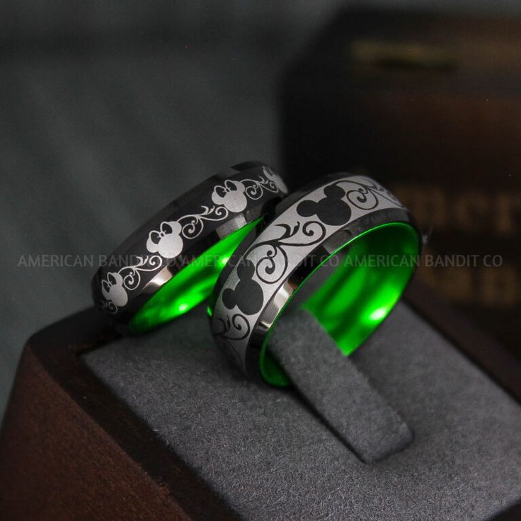 two wedding rings with green light in the middle