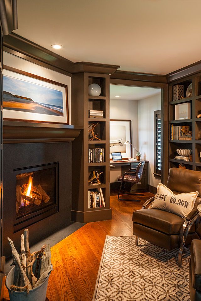 a living room filled with furniture and a fire place next to a bookshelf