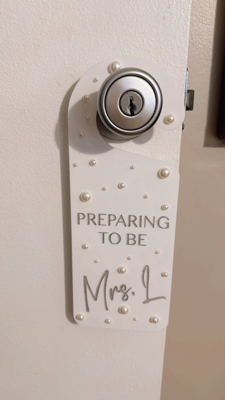 a white door with a sign that says preparing to be mrs l