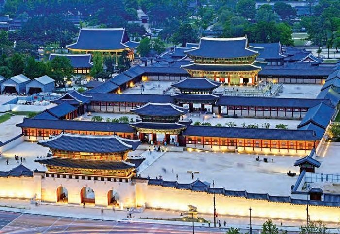 an aerial view of the forbidden city in china, with many buildings lit up at night