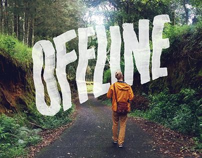 a person walking down a road with the words offline painted on it