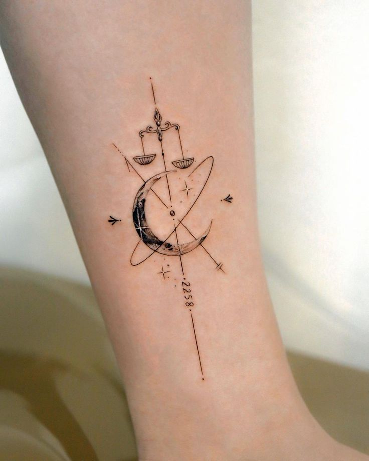 a woman's foot with a small tattoo on the side of her leg and an arrow