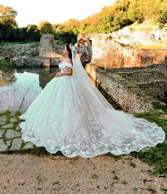 a woman in a wedding dress standing next to another woman