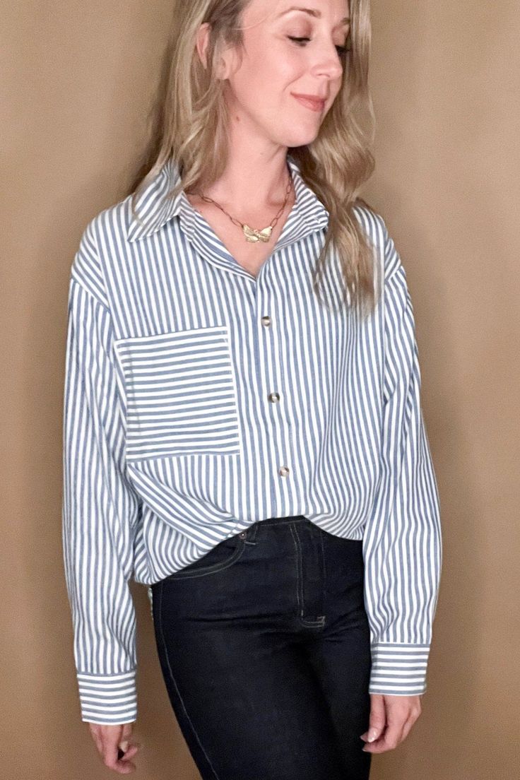 This Classic Stripe Shirt is perfect for the modern sophisticate. Crafted from a luxurious cotton-poly blend, it is soft and stylish while also resistant to wrinkles and maintaining its shape. The classic blue vertical striped design is complemented with a statement front pocket featuring horizontal stripes for an eye-catching finish. Details: Blue Stripes with black pinstripe edging on each stripe Detailed pocket Contents: Cotton, Polyester Blend Fit: True to Size, Amber is 5'6" modeling a small. Imported. Dripping Springs Texas, Nickel And Suede, Stripe Shirt, How To Make Handbags, Horizontal Stripes, Vertical Stripes, Classic Blue, Ethical Fashion, Classic Shirt