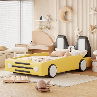 a child's bedroom with a yellow car bed and toys on the wooden floor