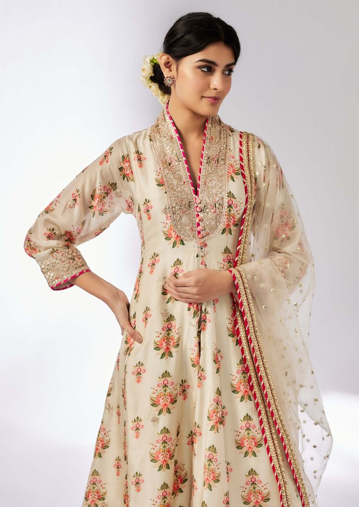 Elevate your style with this delicately embroidered ensemble that adds shimmer and richness. The long-sleeved, front-open kurta in luxurious cotton silk pairs beautifully with linen satin palazzo pants and a sheer net dupatta. Easy to carry and perfect for any occasion, this set effortlessly blends elegance with versatility. Tissue Silk Anarkali Set With Sheer Dupatta, Elegant Long Sleeve Tussar Silk Salwar Kameez, Eid Tussar Silk Palazzo Set With Sheer Dupatta, Long Sleeve Tissue Silk Lawn Suit, Festive Elegant Long Palazzo Set, Floral Embroidered Cotton Silk Lawn Suit For Wedding, Long Chanderi Sets, Eid Wedding Cotton Silk Palazzo Set, Elegant Cotton Silk Anarkali Set With Long Sleeves