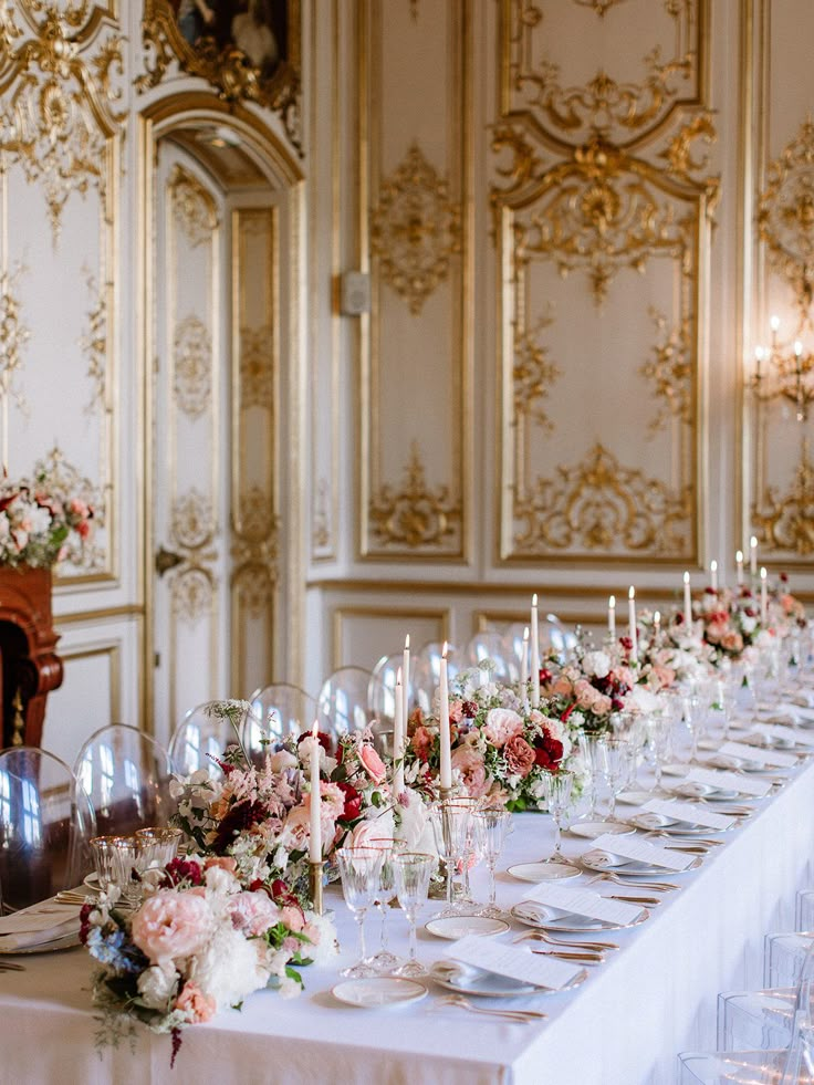 a long table is set up with wine glasses and place settings for an elegant dinner