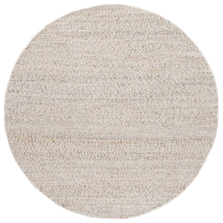 a round rug with white and beige colors on the bottom, in an oval shape