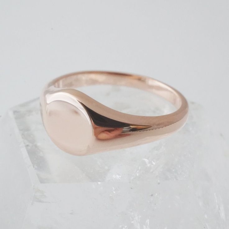 A miniature, sweet signet ring in a slim band with a flat, blank top. Our materials make for an amazing, high quality, seamless, jewelry piece with longevity. Our rings are plated with 18k gold, 18k rose gold, or sterling silver and finished with a protective coating. A little secret we’ll keep between us: it looks way more than it costs. Need help finding your ring size? See our printable ring size chart. Minimalist 14k Rose Gold Ring, Dainty Rose Gold Initial Ring With Tarnish Resistance, Dainty Rose Gold Initial Ring Tarnish Resistant, Dainty Rose Gold Initial Ring, Tarnish Resistant, Classic Rose Gold Sterling Silver Stackable Rings, Modern Rose Gold Sterling Silver Ring, Minimalist Jewelry With Smooth Bezel As Gift, Minimalist Jewelry With Smooth Bezel For Gifts, Minimalist Jewelry With Smooth Bezel Gift