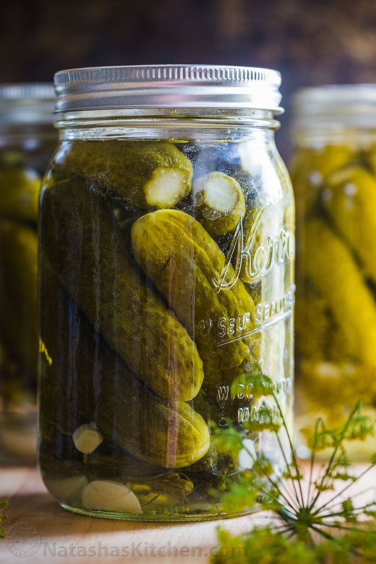 pickled cucumbers in jars on a table