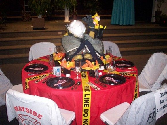 a table set up with plates and napkins for a firefighter's birthday party