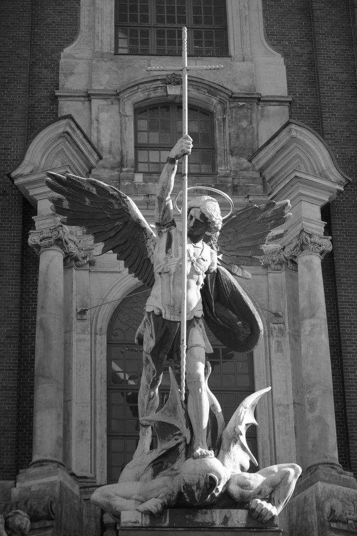 an angel statue is in front of a building