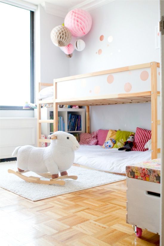 a child's bedroom with bunk beds and pink polka dot decorations on the walls