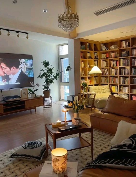 a living room filled with furniture and a flat screen tv mounted to the side of a wall