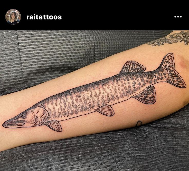 a fish tattoo is shown on the arm