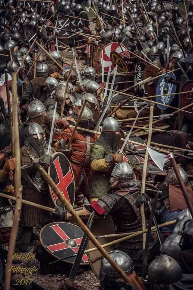 a large group of people with helmets and swords