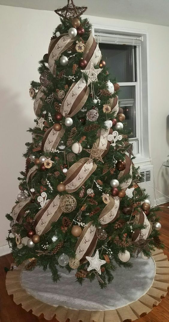 a christmas tree decorated with ribbons and ornaments