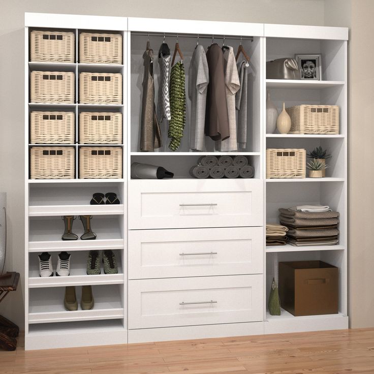 a white closet filled with lots of drawers and baskets on top of it's shelves