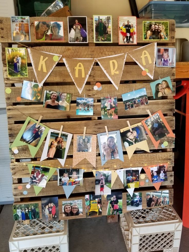 a wooden pallet with pictures hanging on it