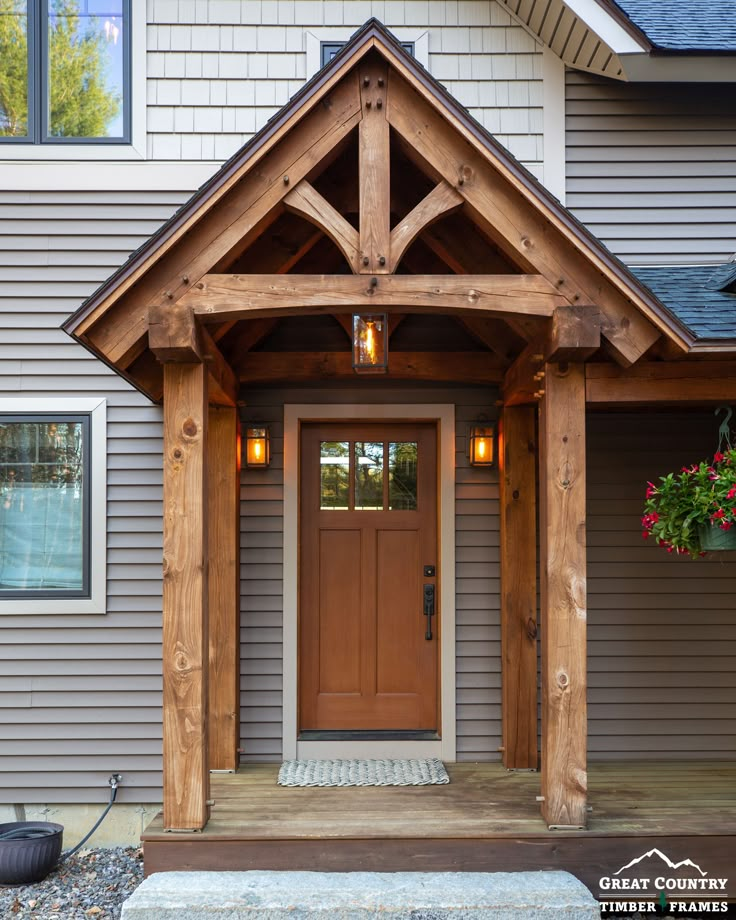 the front entrance to a house with wood trimming