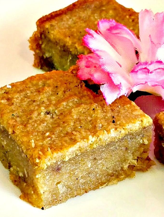 two pieces of cake sitting on top of a white plate next to a pink flower