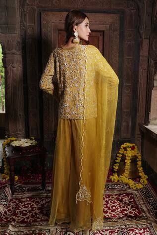 Yellow jacket style kurta with thread embroidered blossom vine motifs, embellished by beads and swarovski. Comes with sharara and scalloped border dupatta. - Aza Fashions Festival Long Sleeve Sharara With Dori Work, Yellow Embroidered Chinon Sharara, Yellow Semi-stitched Sharara With Motifs, Embroidered Semi-stitched Orange Sharara, Transitional Yellow Embroidered Sharara, Semi-stitched Yellow Sharara With Motifs, Jacket Sharara, Rhea Kapoor, Huma Qureshi