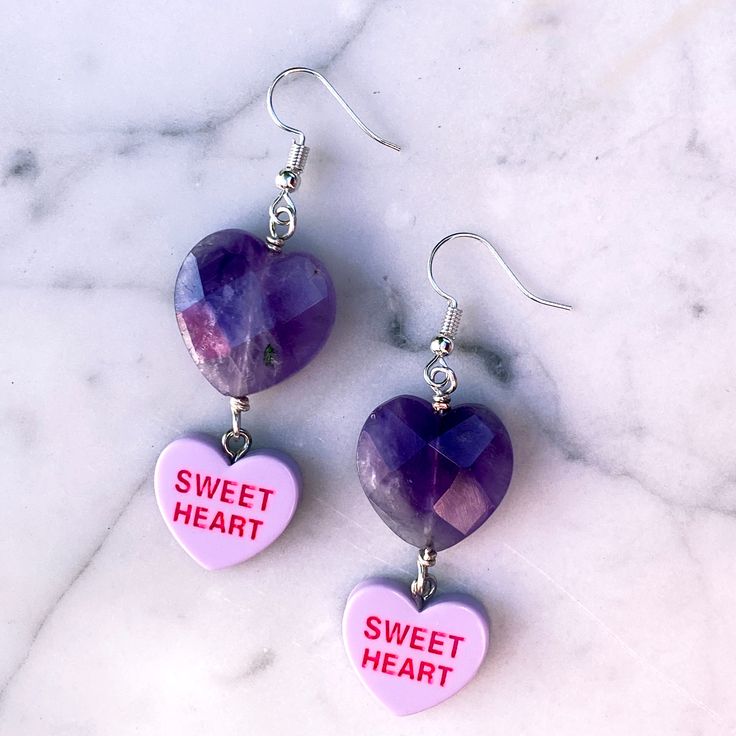 Gemstones are genuine amethyst metal is stainless steel earring wires are hypoallergenic Trendy Dangle Heart Earrings With Ear Wire, Trendy Purple Jewelry For Gift, Nickel-free Dangle Jewelry For Valentine's Day, Heart Cut Metal Earrings For Gift, Metal Heart Cut Earrings As Gift, Nickel-free Lavender Earrings Gift, Purple Dangle Heart Earrings For Pierced Ears, Metal Heart Dangle Earrings For Gift, Gift Lavender Nickel-free Earrings