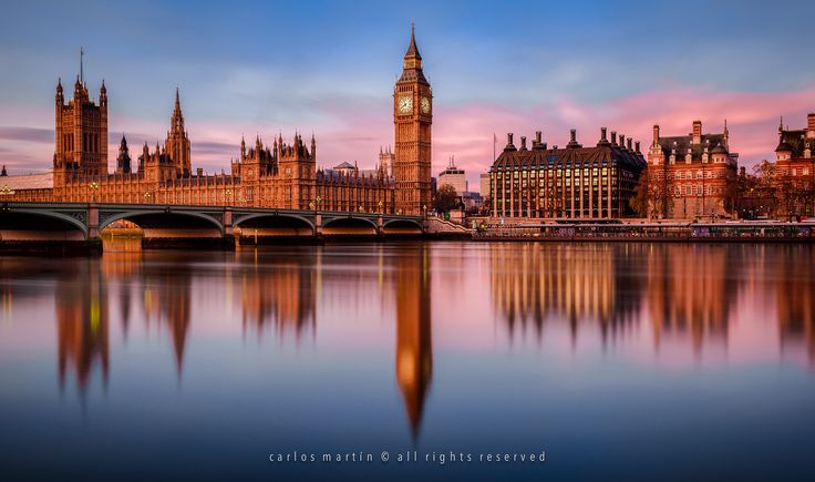 the big ben clock tower towering over the city of london, england at sunset or dawn